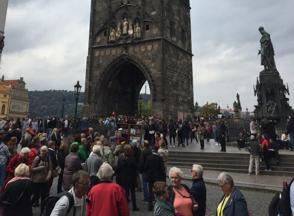 Movimento de pessoas próximo a Ponte Carlos em Praga em um dia cinzento de outono